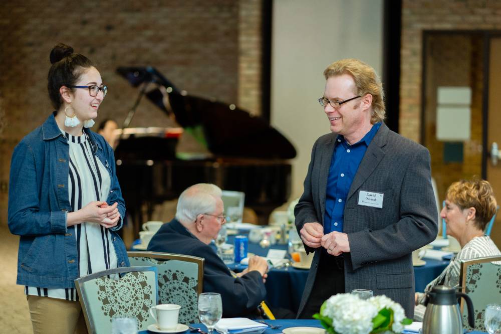 Man and woman talking to each other at Scholarship Dinner 2019
